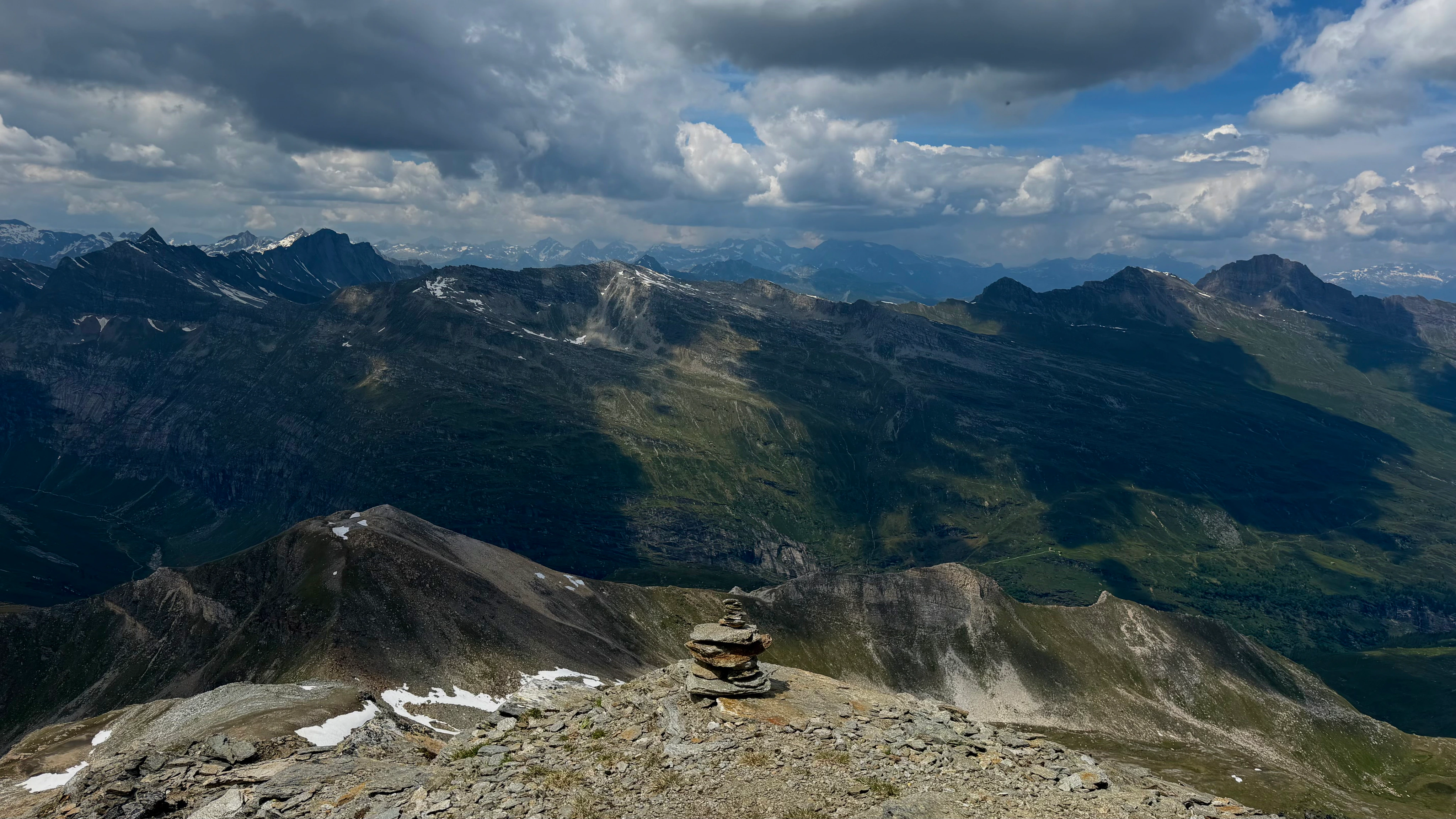 A high Alpine ridgeline extending toward distant ranges.