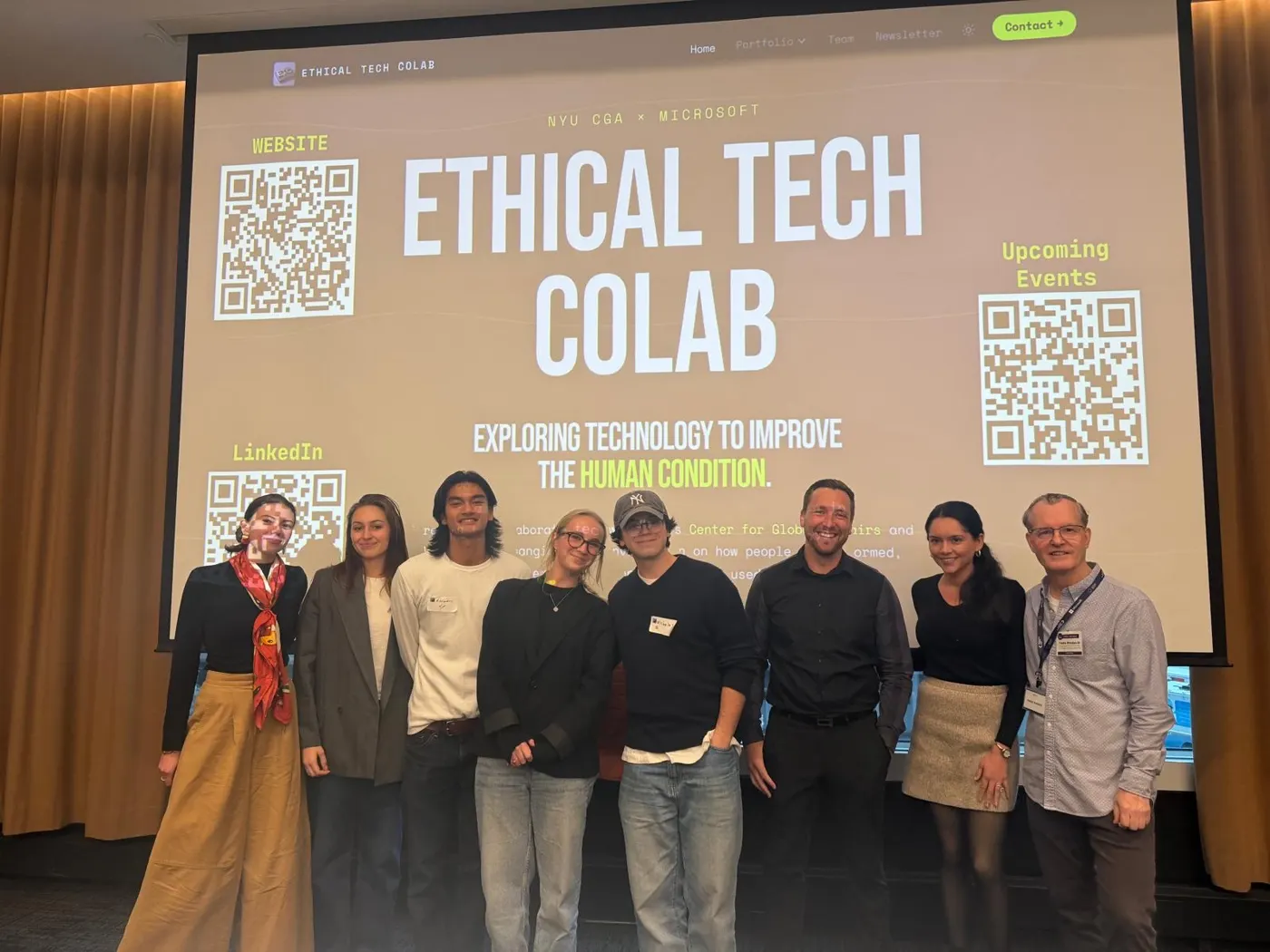 The team with others in front of a screen reading Ethical Tech Colab, NYU CGA × Microsoft.