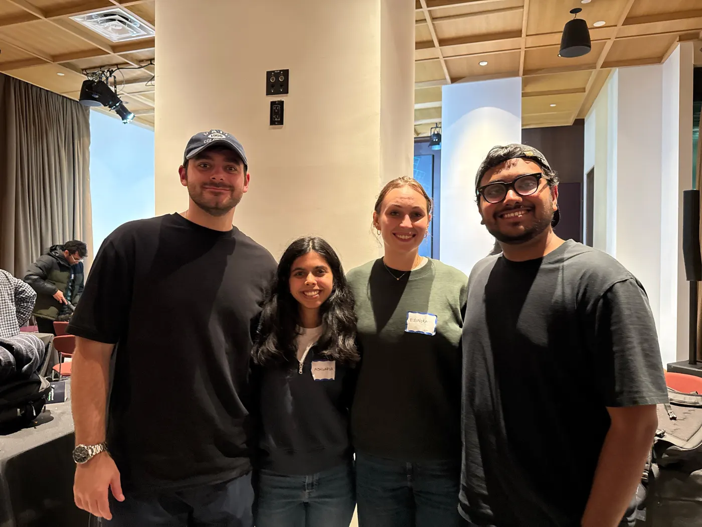 Eleonora and three teammates smiling in the hackathon room.
